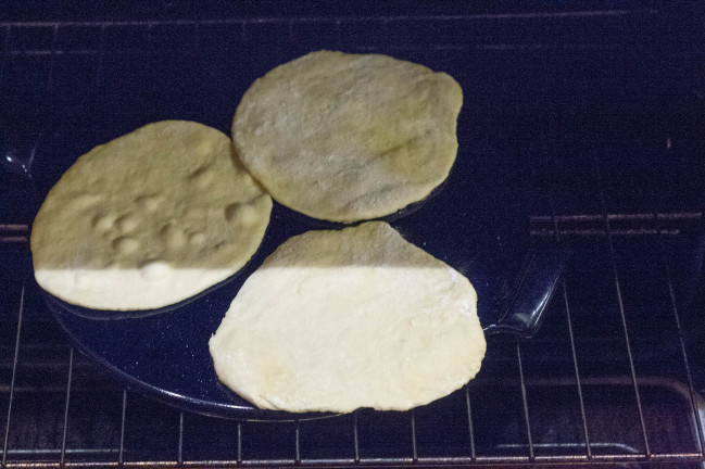 homemade pita bread puffing in oven