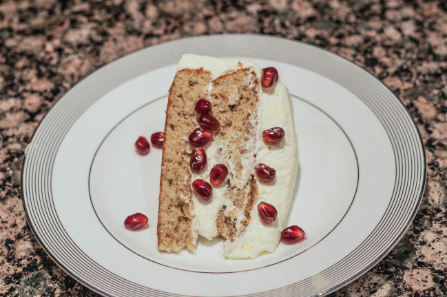 persian love cake sliced with pomegranates