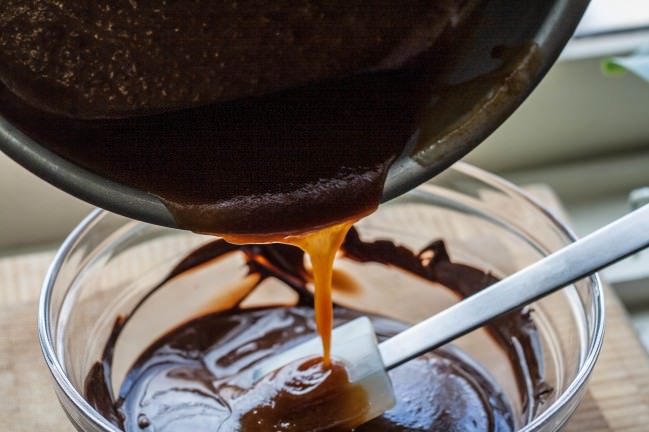 pouring caramel into chocolate