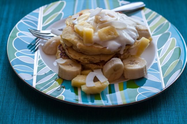 side view coconut pancakes with pineapple and yogurt