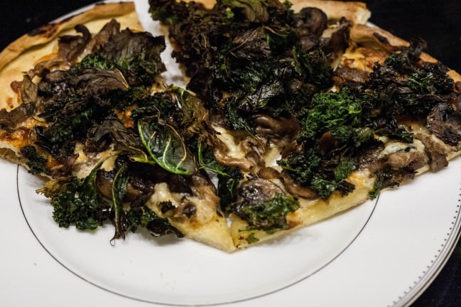 slices of mushroom and kale pizza