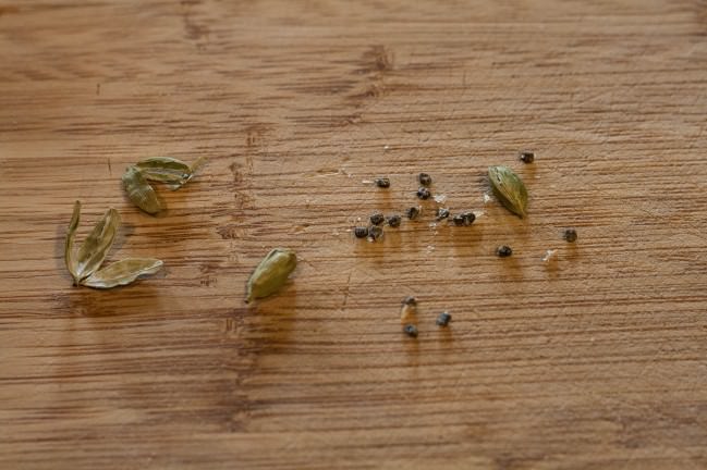 breaking open cardamom pods