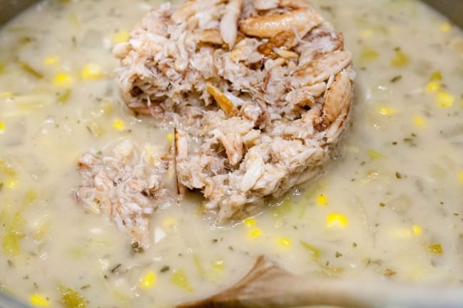 adding crab to corn crab chowder