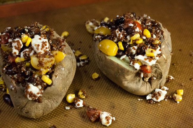 sweet potatoes stuffed with quinoa, black beans, tomatoes, feta and corn