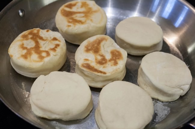 english muffins in pan ready to flip