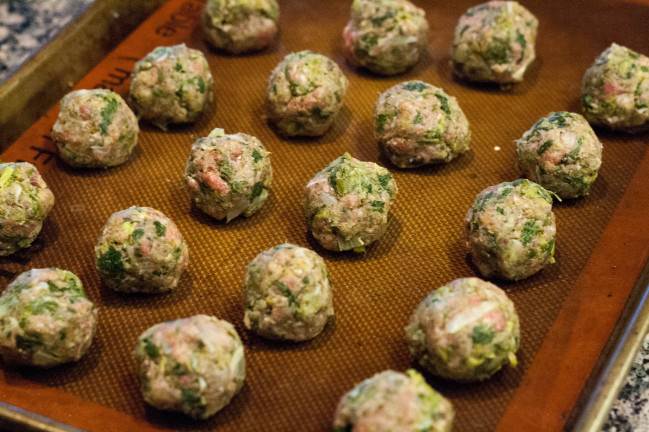 lemony leek meatballs on baking sheet