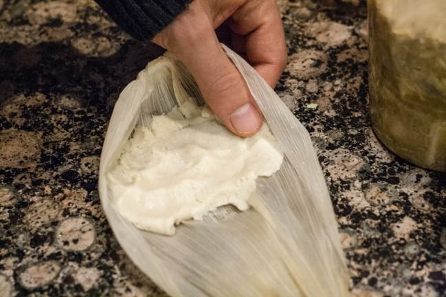 tamales dough pressed into husk