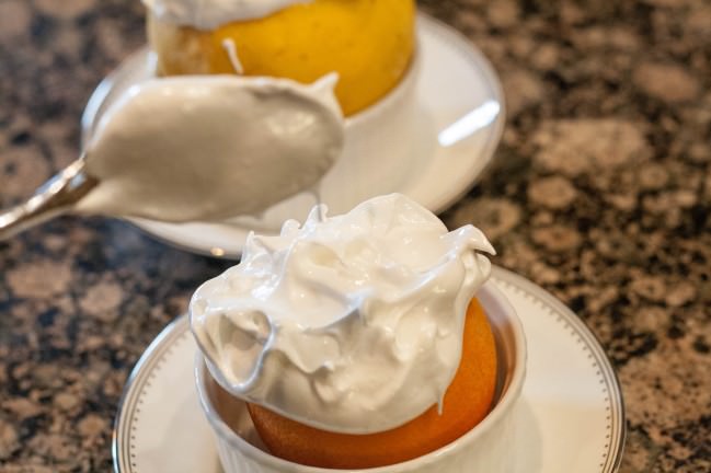 Orange a la Norvegienne spooning on the meringue