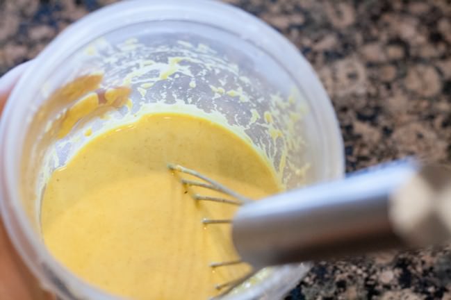 Leftover Crab Dip Crepes whisking tumeric batter