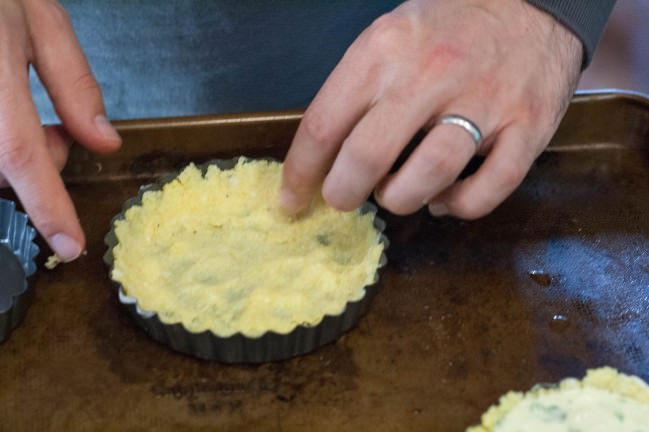 Spicy Polenta Tarts with Okra and Sweet Corn pressing into pans