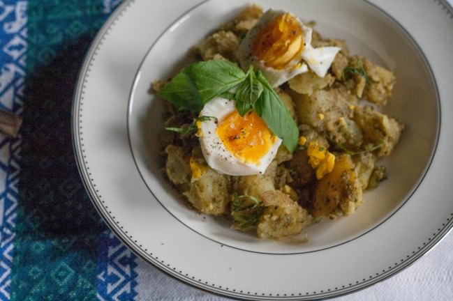 Pesto Potatoes with Soft-Boiled Eggs and basil leaves
