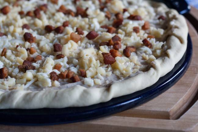 Runny Egg Pizza (Guanciale Béchamel) topped with cheese and lardons