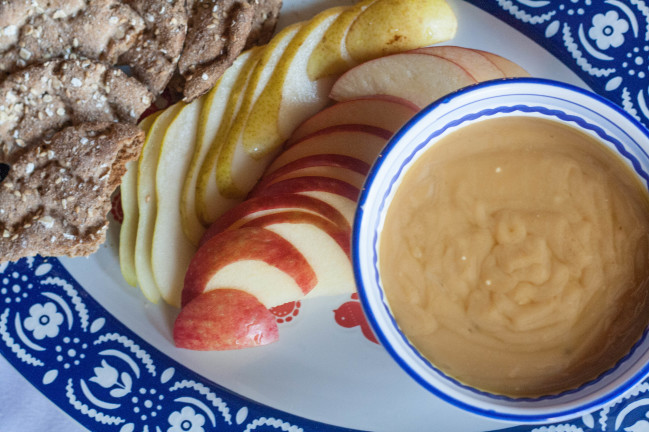 Swedish Gjetost Fondue with sliced fruit and crisps